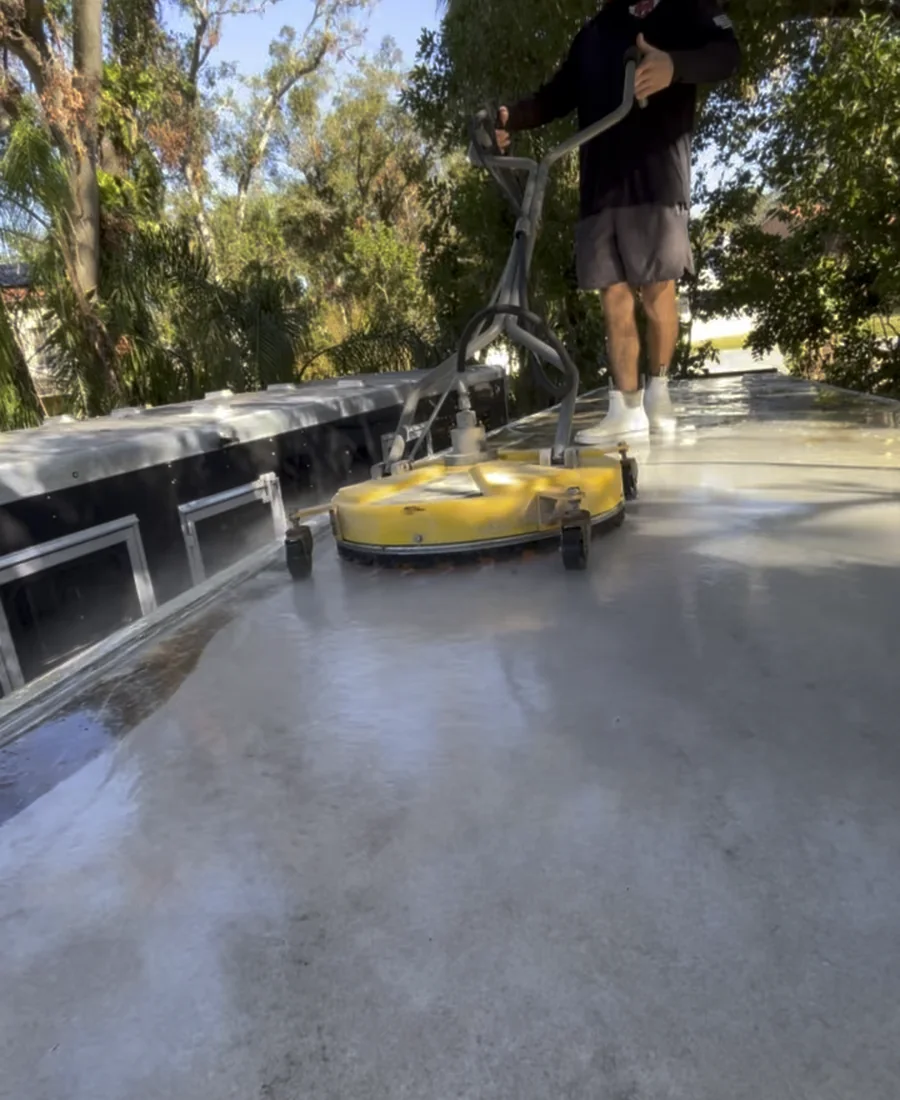 Professional surface cleaner washing a residential patio
